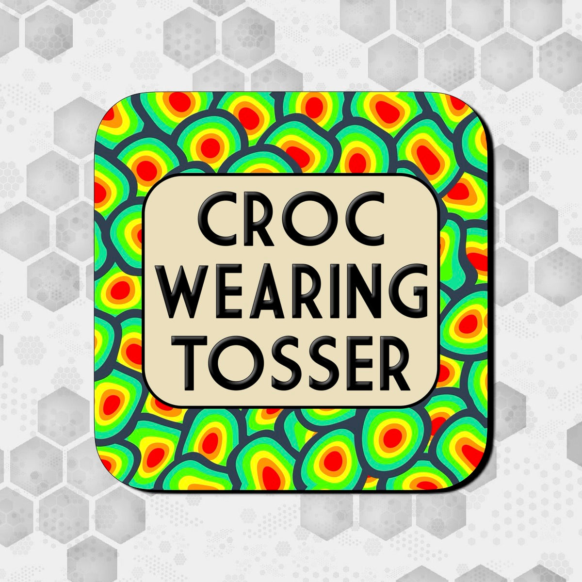 A square coaster with a multicolored pattern and text 'CROC WEARING TOSSER' in the center.