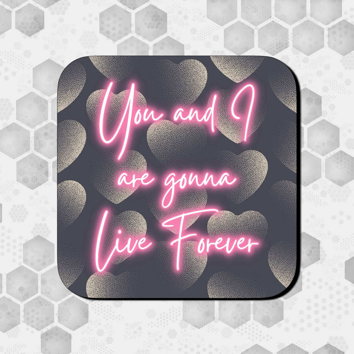 A square coaster with a dark background and pink text that reads 'You and I are gonna Live Forever', with a heart pattern in the design. OASIS LYRICS