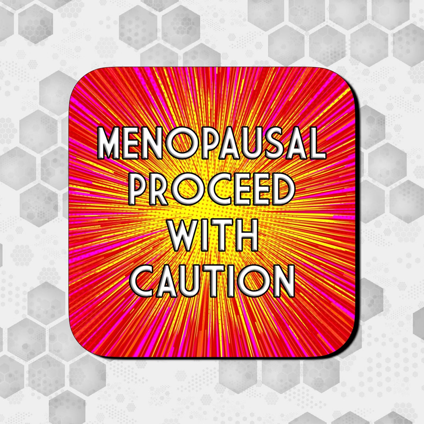 Coaster with a bold red, pink, and yellow comic-style burst background, featuring large centered text that reads ‘Menopausal Proceed With Caution