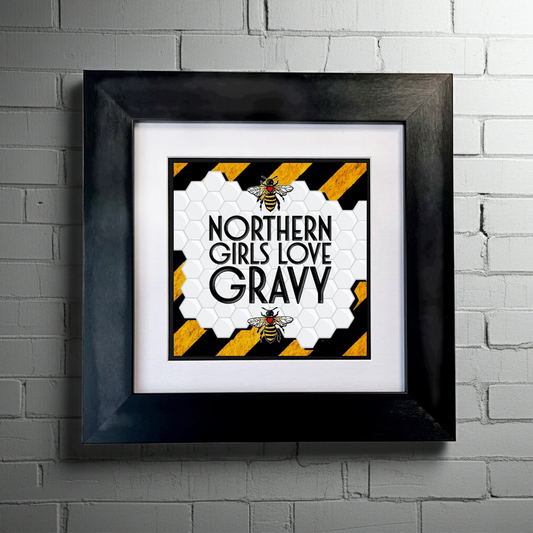 Framed artwork with 'Northern Girls Love Gravy' text and bee design on a white background.