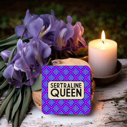 Coaster with a vivid pink and blue geometric floral pattern, featuring a rounded beige box in the center with bold black text reading ‘Sertraline Queen