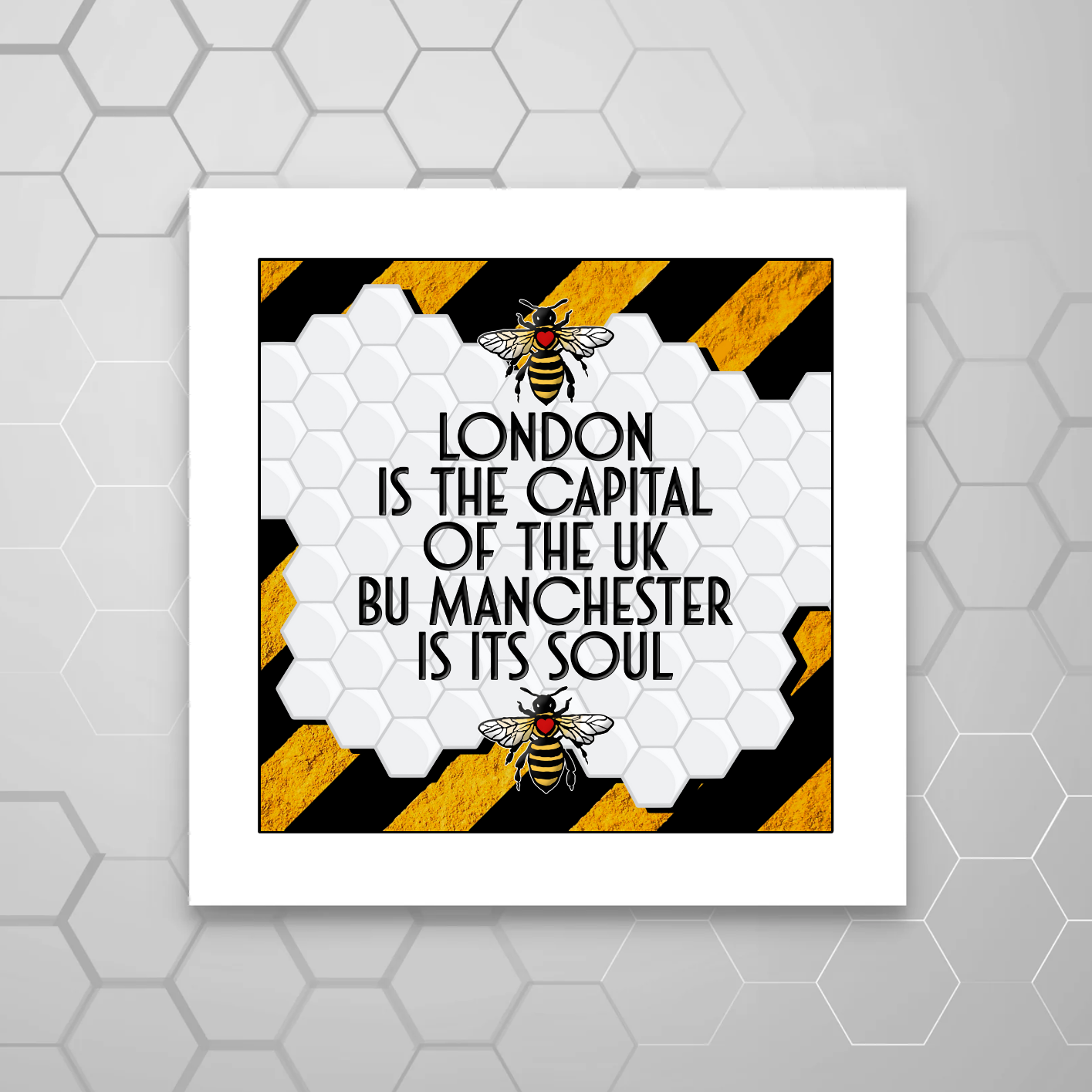 A MOUNTED print with a STRIPE pattern and yellow bees, containing the text 'LONDON IS THE CAPITAL OF THE UK BUT MANCHESTER IS ITS SOUL'.