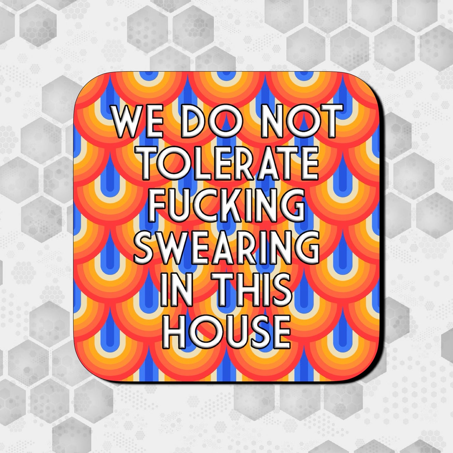 Coaster with a bold retro scalloped pattern in red, orange, yellow, and blue, featuring large centered text that reads ‘We do not tolerate fucking swearing in this house