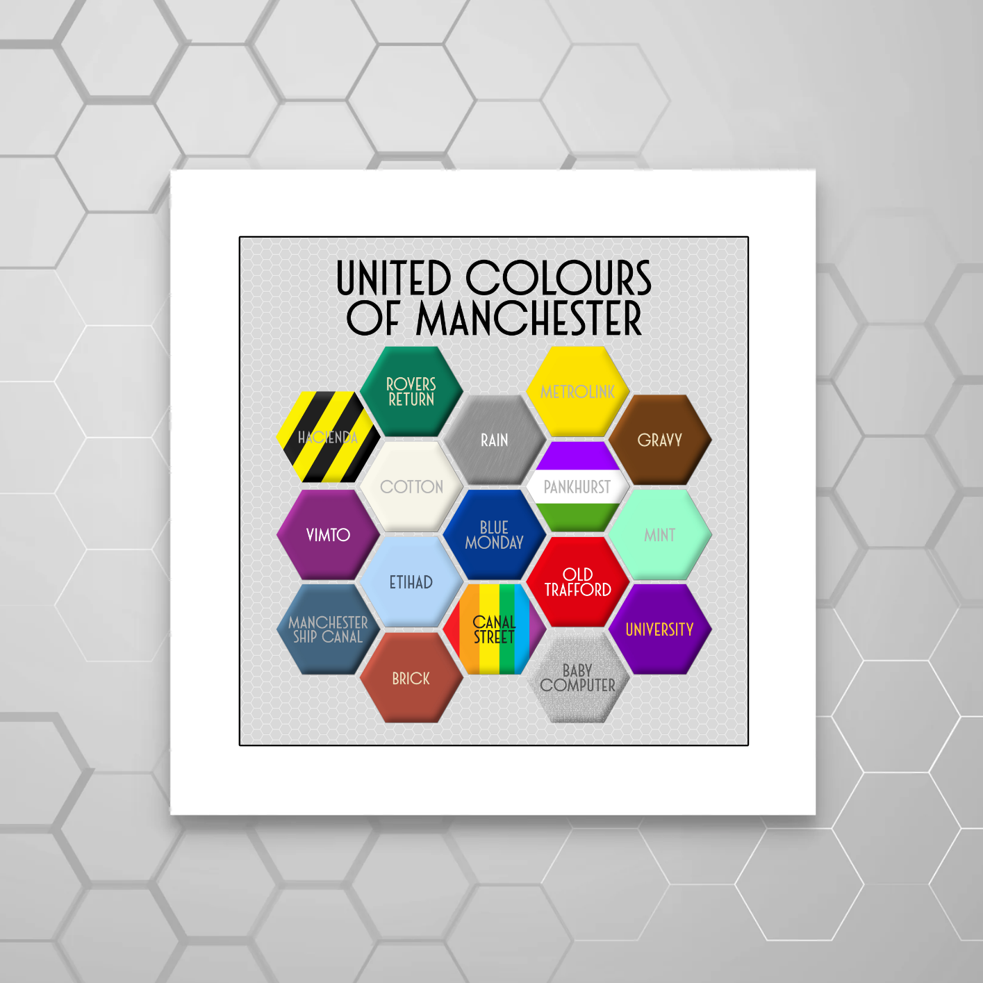 A colourful MOUNTED print titled 'UNITED COLOURS OF MANCHESTER', featuring a honeycomb pattern with different colours and text elements representing various aspects of Manchester.