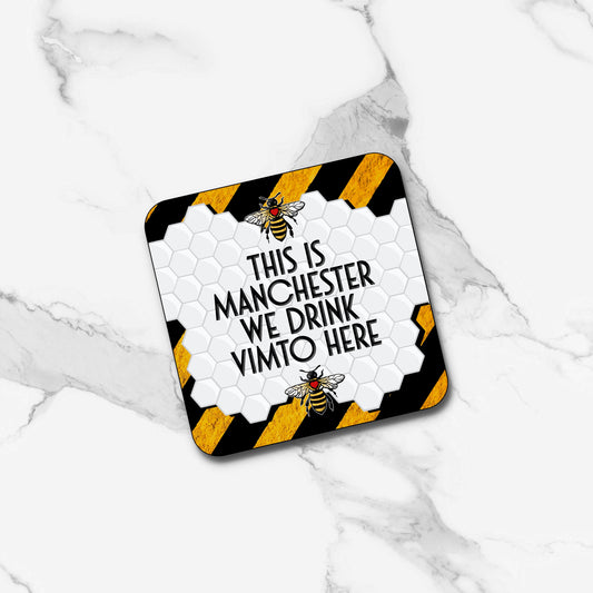 SQUARE THIS IS MANCHESTER WE DRINK VIMTO HERE COASTER WITH YELLOW AND BLACK STRIPE BACKGROUND FEATURING TWO MANCHESTER BEES