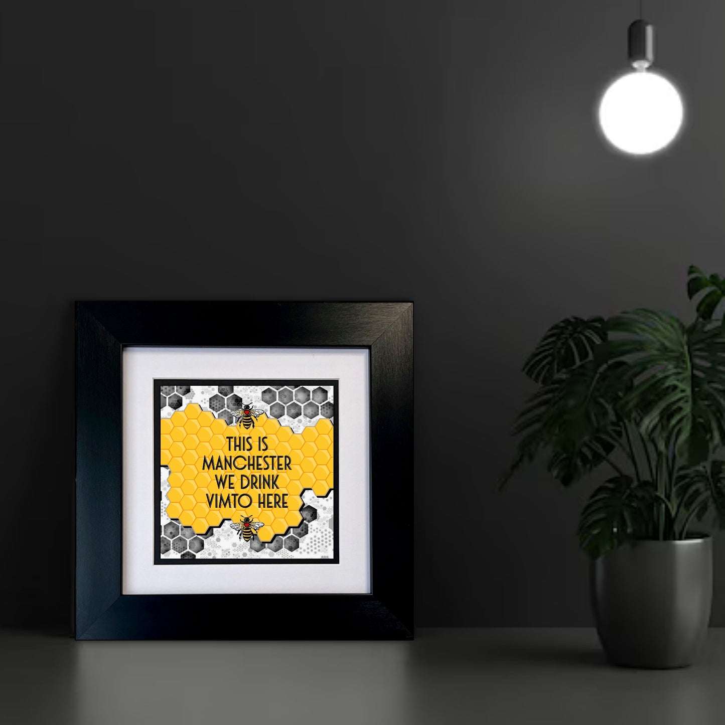 Framed print with 'This is Manchester, we drink Vimto here' text on a YELLOW HONEYCOMB BACKGROUND TWO MANCHESTER BEES