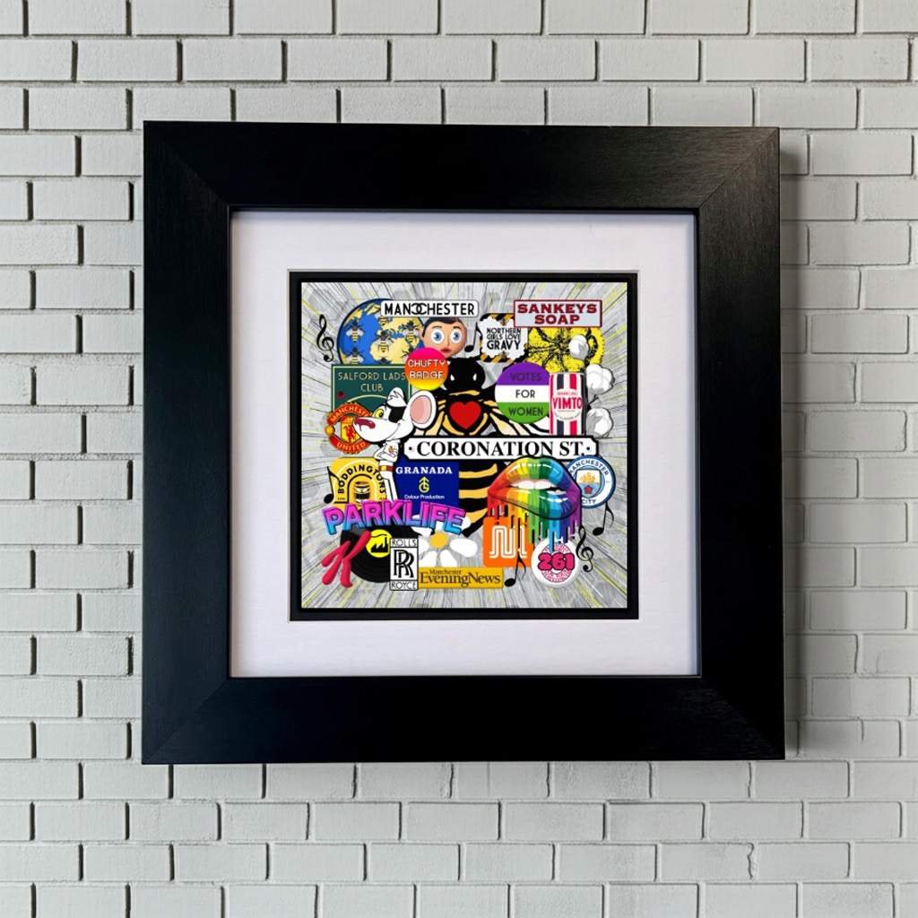 Framed MANCHESTER ICONS artwork with colourful design on a WHITE BRICK WALL SU MACE GIFTS