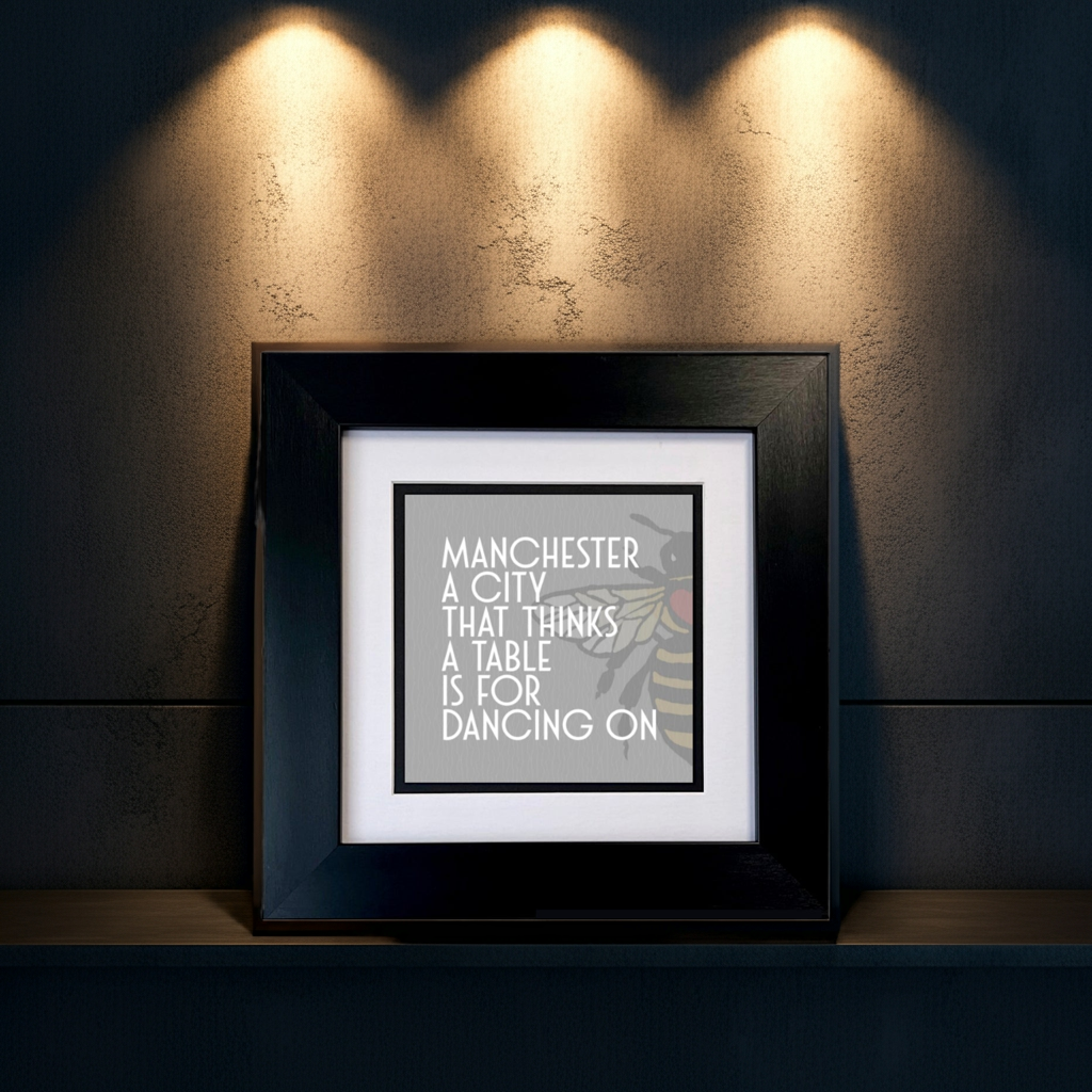 MANCHESTER A CITY THAT THINKS A TABLE IS FOR DANCING ON FRAMED PRINT