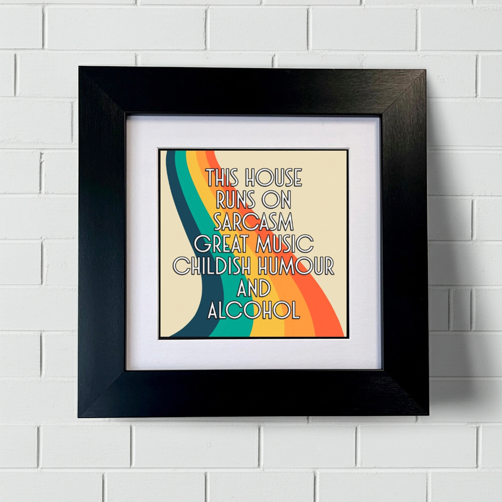 Framed artwork with colorful design and text on a white brick wall background