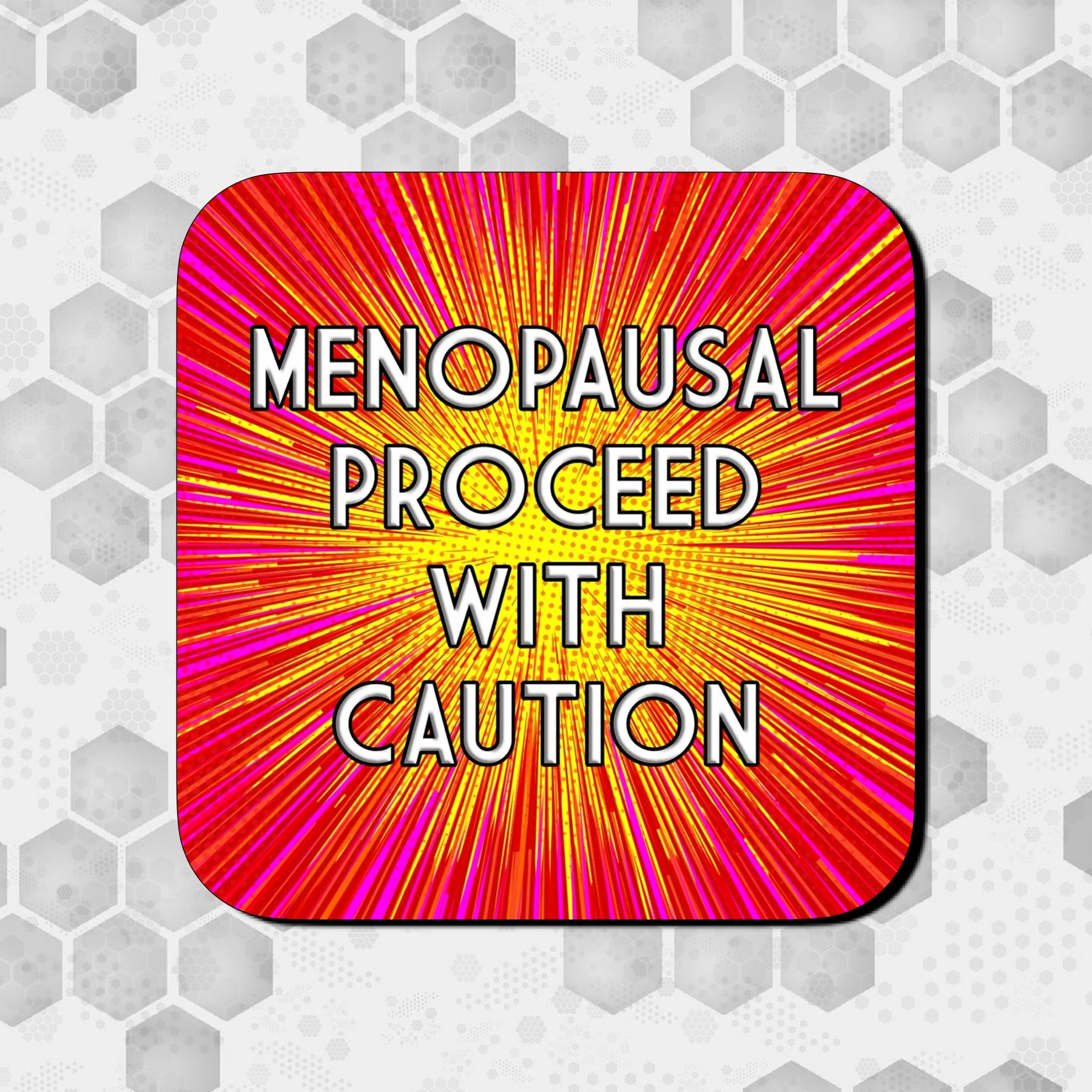 Coaster with a bold red, pink, and yellow comic-style burst background, featuring large centered text that reads ‘Menopausal Proceed With Caution