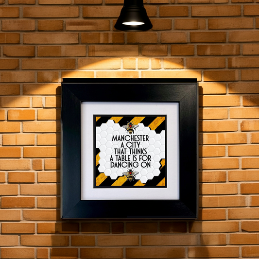 MANCHESTER A CITY THAT THINKS A TABLE IS FOR DANCING ON FRAMED PRINT