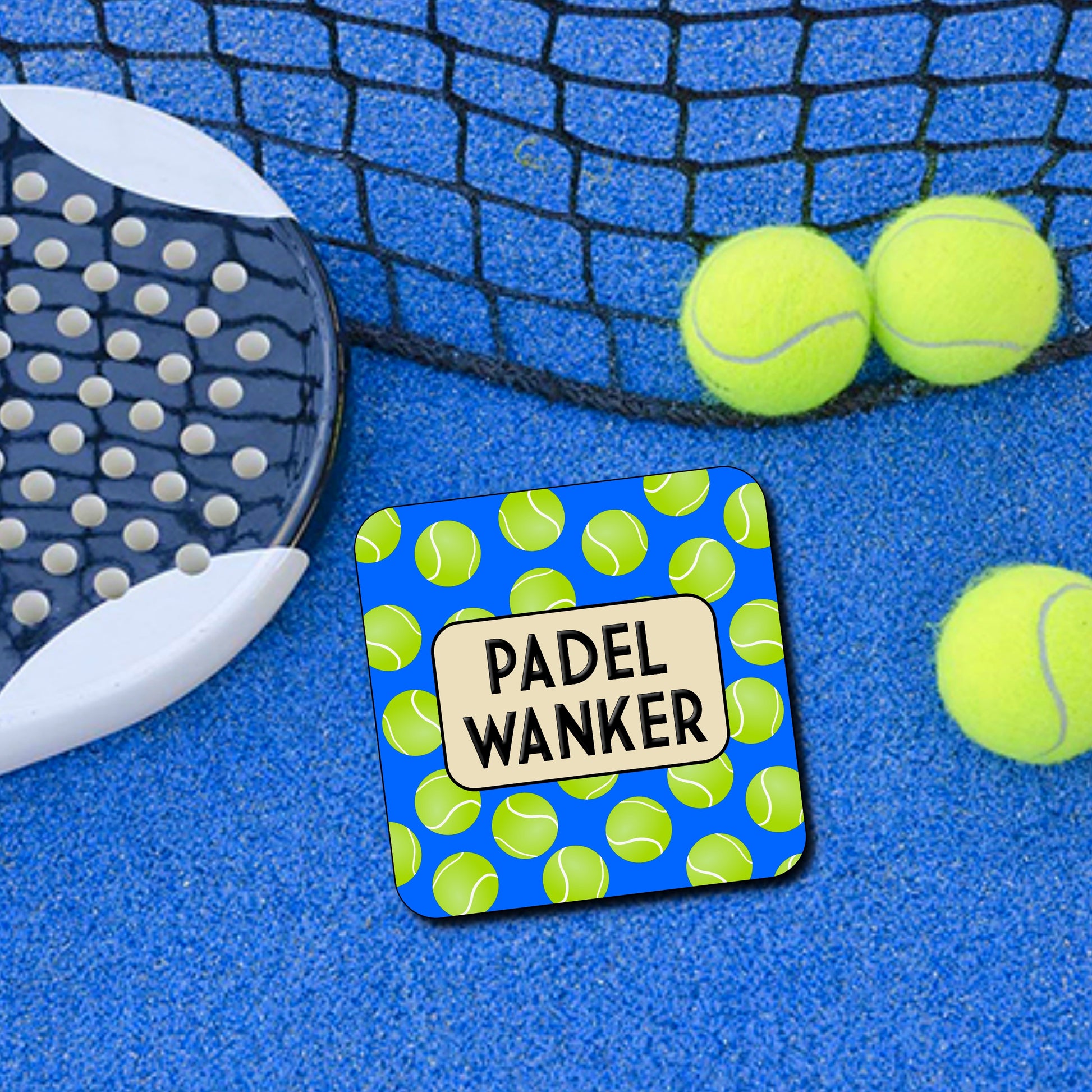 A square coaster with a blue background featuring a green tennis ball pattern and the text 'PADEL WANKER' in the center.