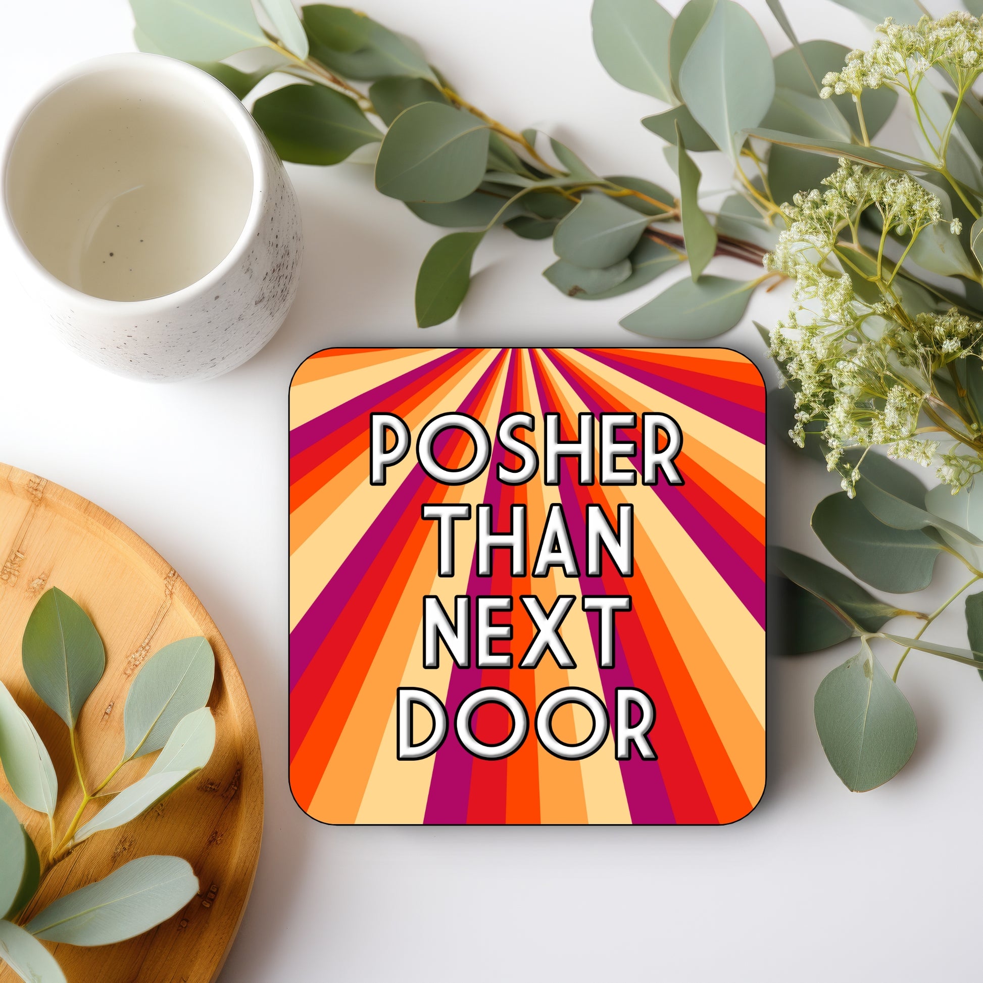 A square coaster with a multicolored STRIPE design and text 'POSHER THAN NEXT DOOR' 