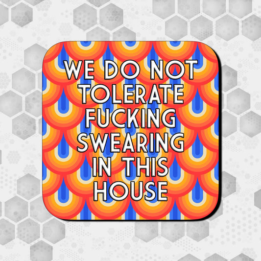 Coaster with a bold retro scalloped pattern in red, orange, yellow, and blue, featuring large centered text that reads ‘We do not tolerate fucking swearing in this house
