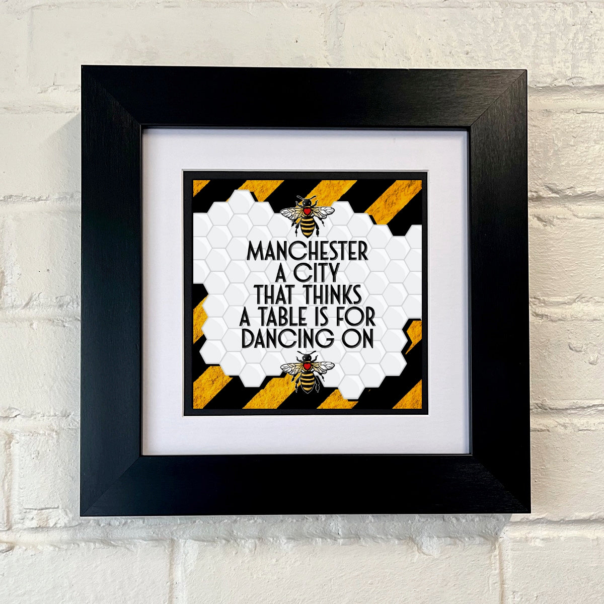 MANCHESTER A CITY THAT THINKS A TABLE IS FOR DANCING ON FRAMED PRINT