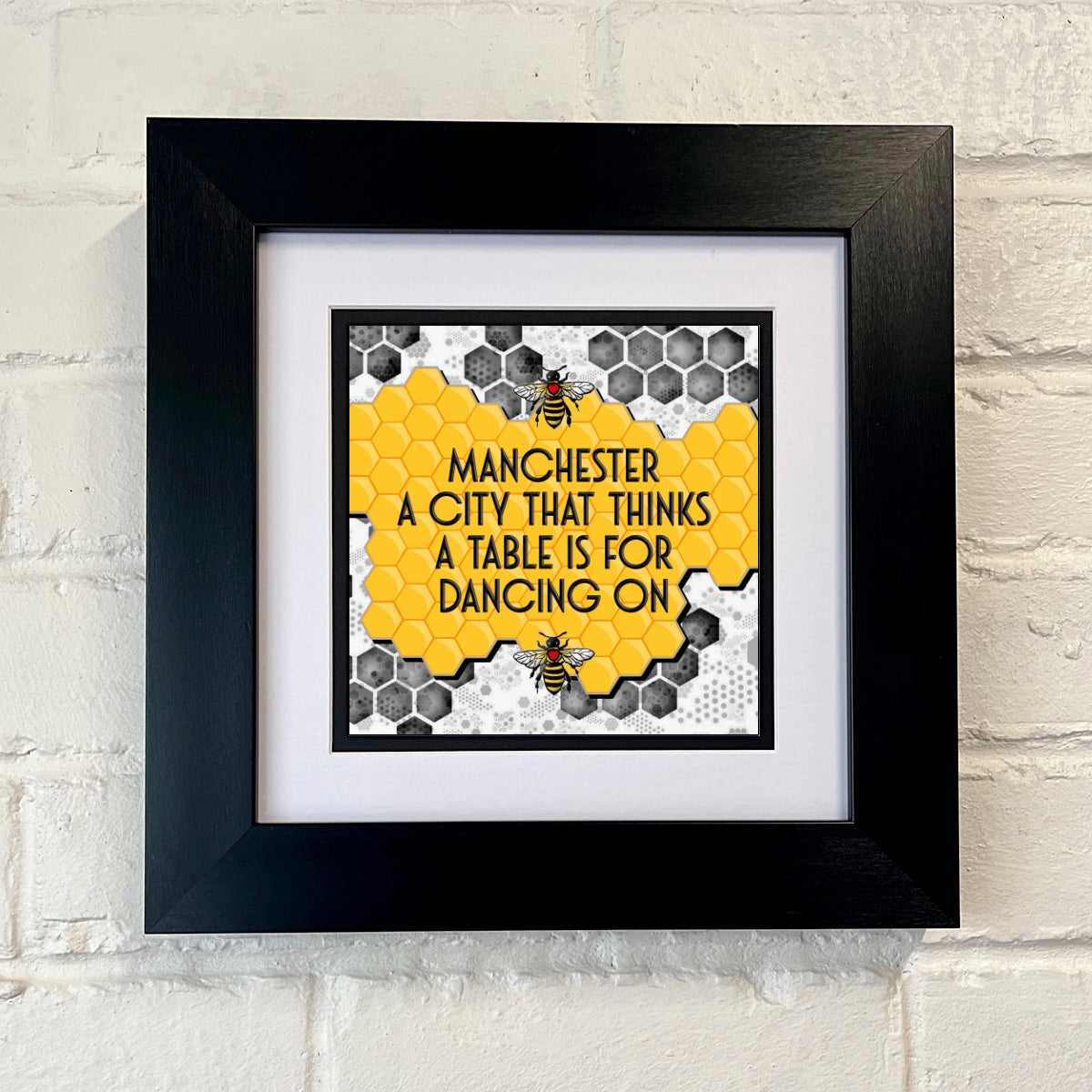 MANCHESTER A CITY THAT THINKS A TABLE IS FOR DANCING ON FRAMED PRINT