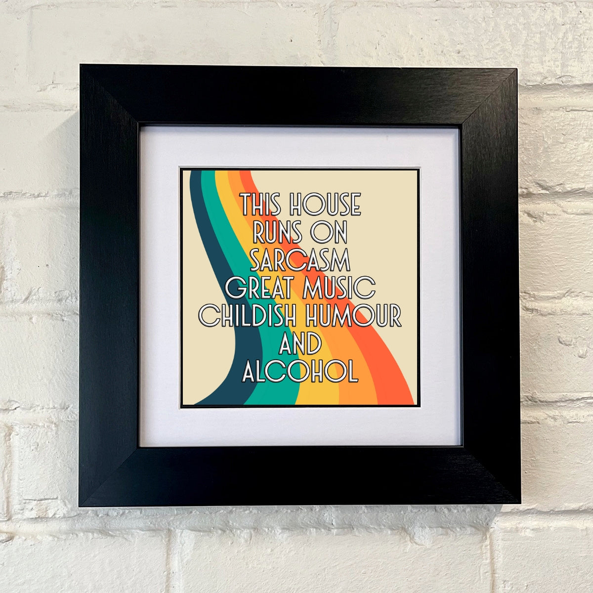 Framed poster with colorful design and text on a brick wall background