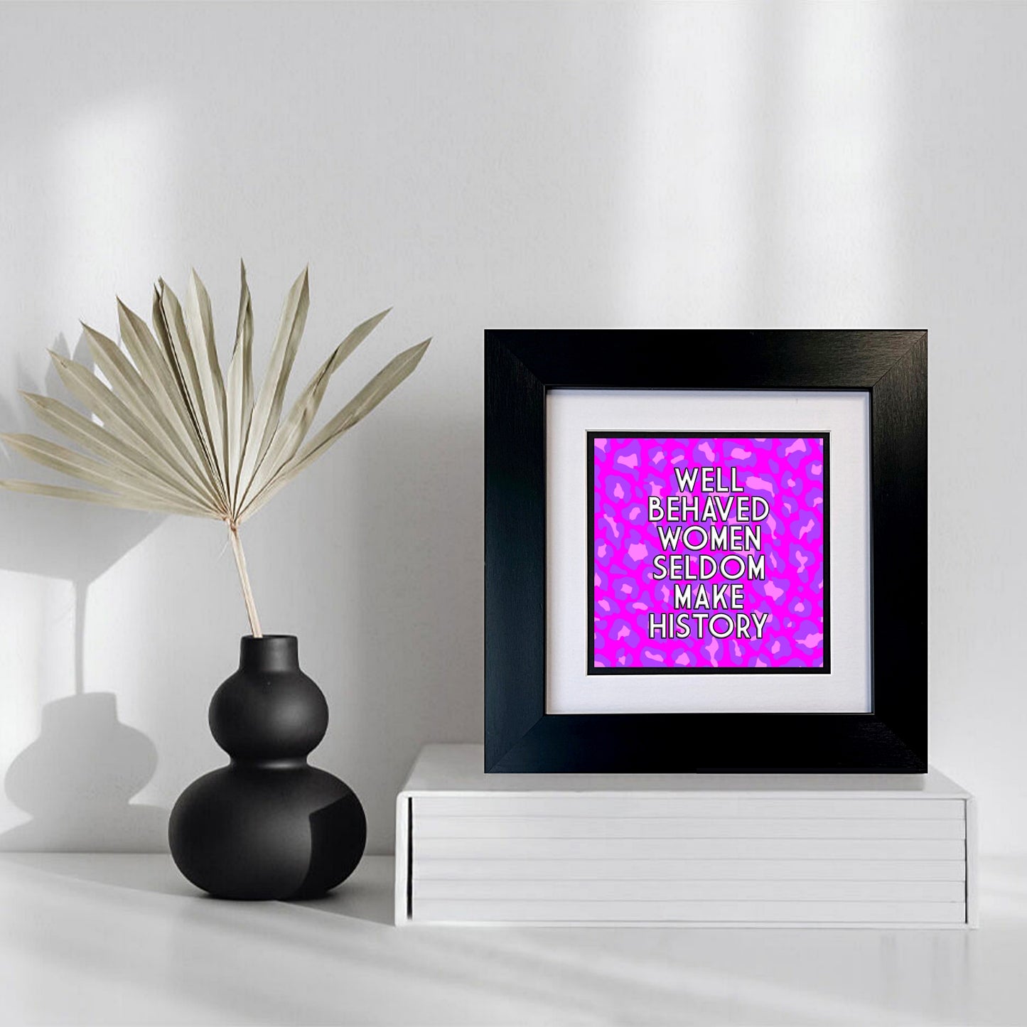 WELL BEHAVED WOMEN SELDOM MAKE HISTORY FRAMED PRINT WITH PINK/PURPLE LEOPARD PRINT BACKGROUND